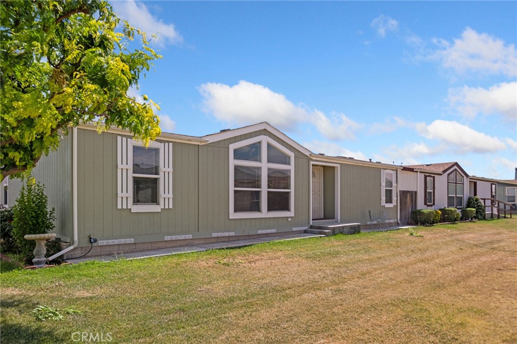 21621 Sandia Road, Unit 128 Apple Valley, CA 92308 - Photo 14 of 41 a view of a house with a yard and garage