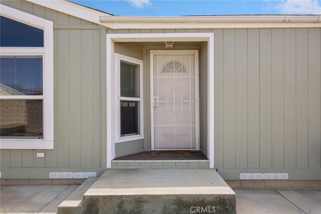 21621 Sandia Road, Unit 128 Apple Valley, CA 92308 - Photo 17 of 41 a view of house with a wooden door