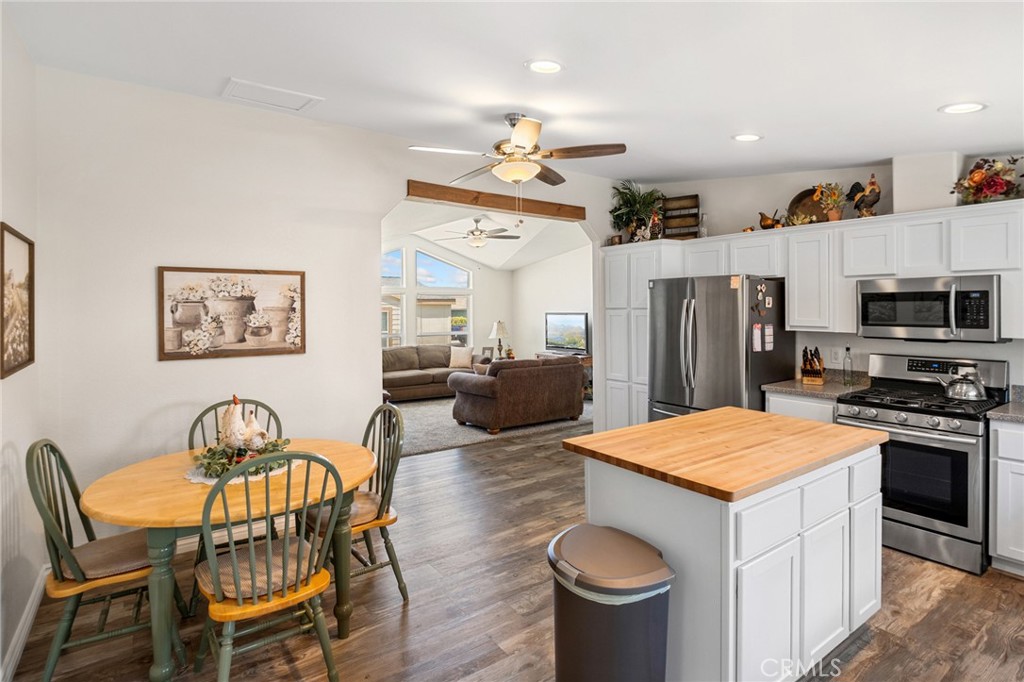 21621 Sandia Road, Unit 128 Apple Valley, CA 92308 - Photo 25 of 41 a open kitchen with stainless steel appliances granite countertop a dining table and chairs