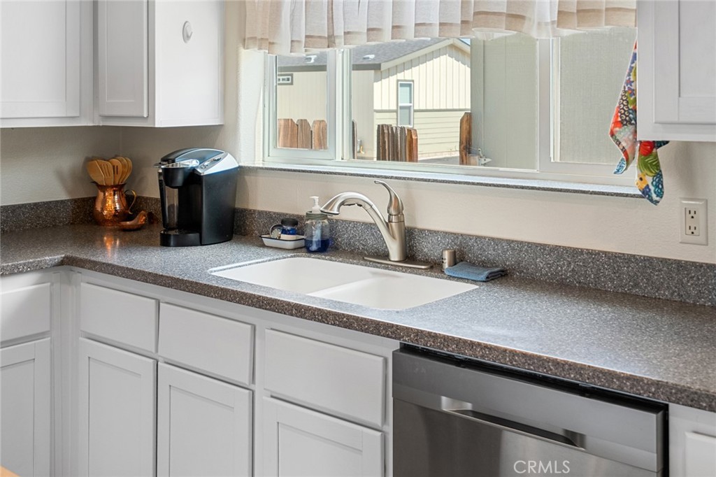 21621 Sandia Road, Unit 128 Apple Valley, CA 92308 - Photo 27 of 41 a kitchen with sink and cabinets