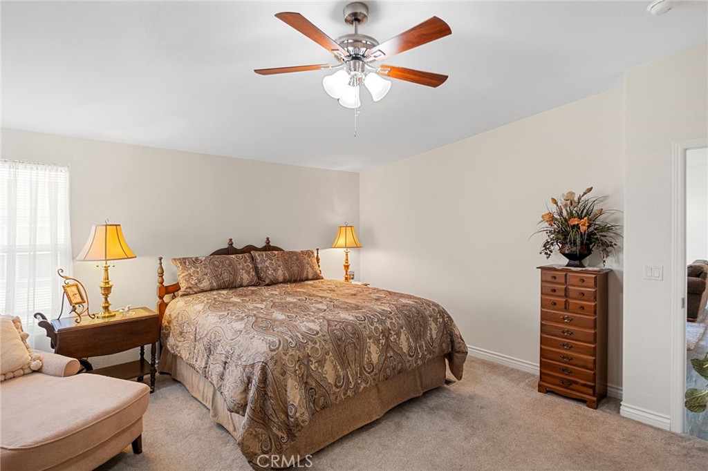 21621 Sandia Road, Unit 128 Apple Valley, CA 92308 - Photo 29 of 41 a bedroom with a bed and a chandelier