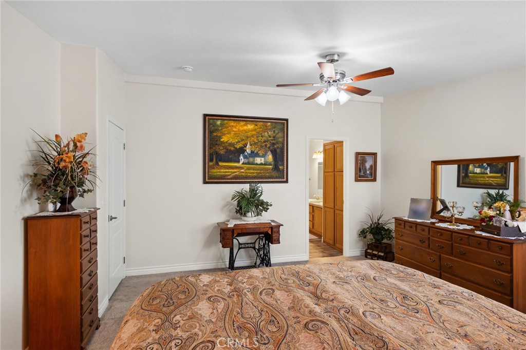21621 Sandia Road, Unit 128 Apple Valley, CA 92308 - Photo 31 of 41 a bedroom with a bed and a chandelier