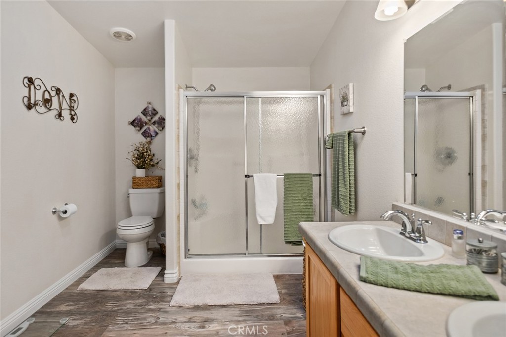 21621 Sandia Road, Unit 128 Apple Valley, CA 92308 - Photo 34 of 41 a bathroom with a granite countertop sink toilet and shower