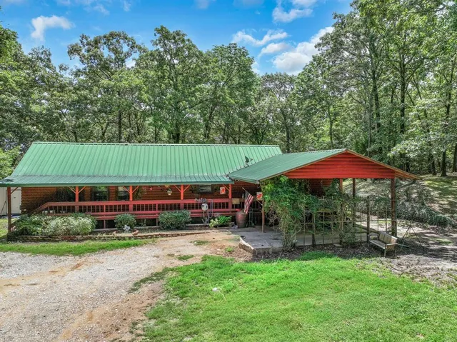 a view of a house with a yard and sitting area