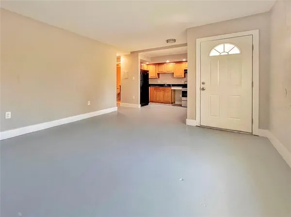 an empty room with fire place and windows