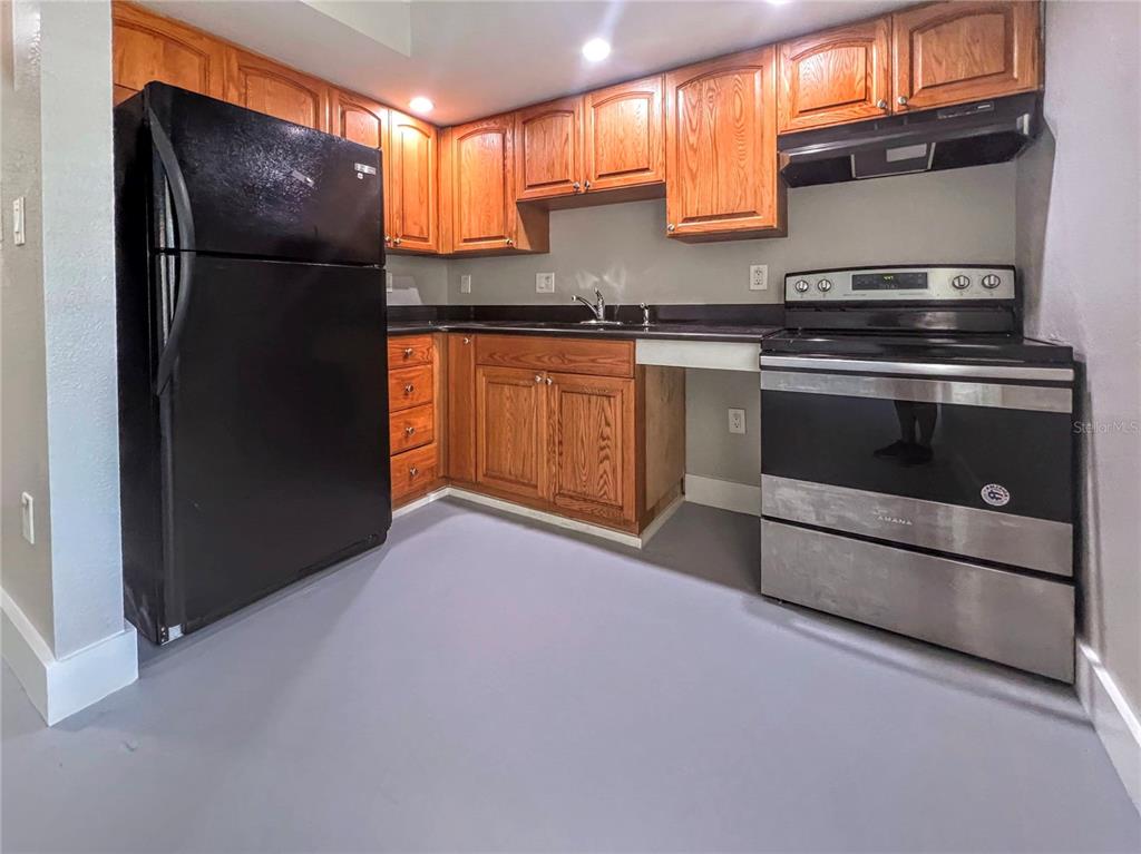 1090 Cocoanut Avenue, Unit 2 Sarasota, FL 34236 - Photo 6 of 8 a kitchen with stainless steel appliances granite countertop a refrigerator and a sink