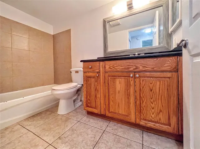 a white toilet sitting next to a bathroom sink and a shower