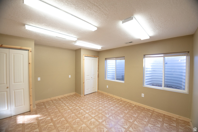 348 North Jakes Pl Road Loa, UT 84747 - Photo 10 of 26 Spare room with a textured ceiling and baseboards
