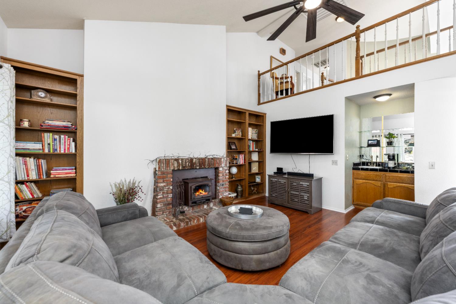 10165 Snowy Owl Way Auburn, CA 95603 - Photo 12 of 48 a living room with furniture a flat screen tv and a fireplace
