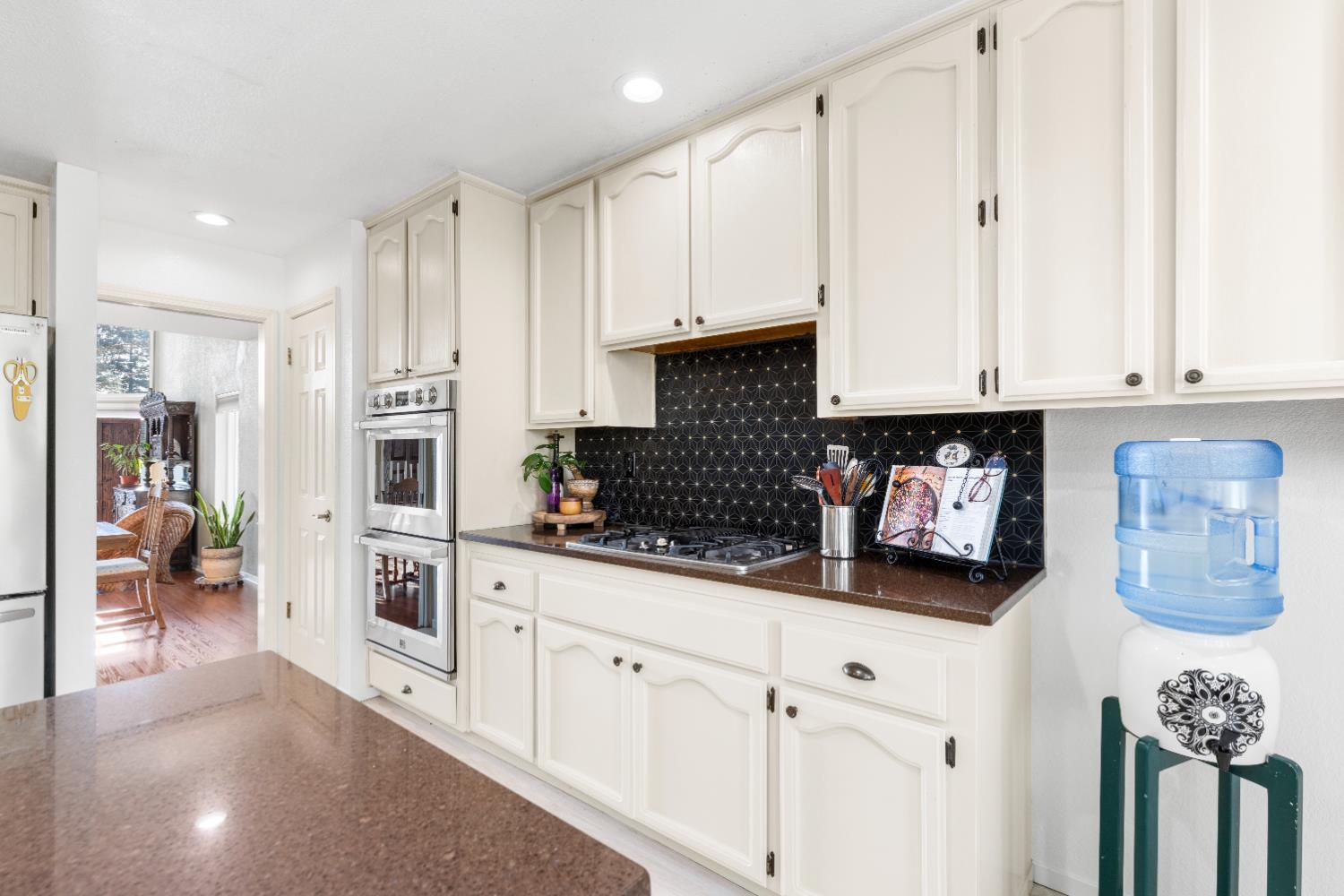 10165 Snowy Owl Way Auburn, CA 95603 - Photo 14 of 48 a kitchen with white cabinets and appliances