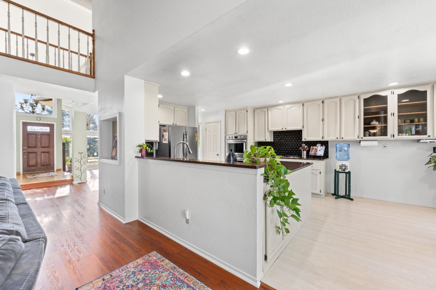 10165 Snowy Owl Way Auburn, CA 95603 - Photo 15 of 48 a kitchen with stainless steel appliances granite countertop a refrigerator sink and cabinets