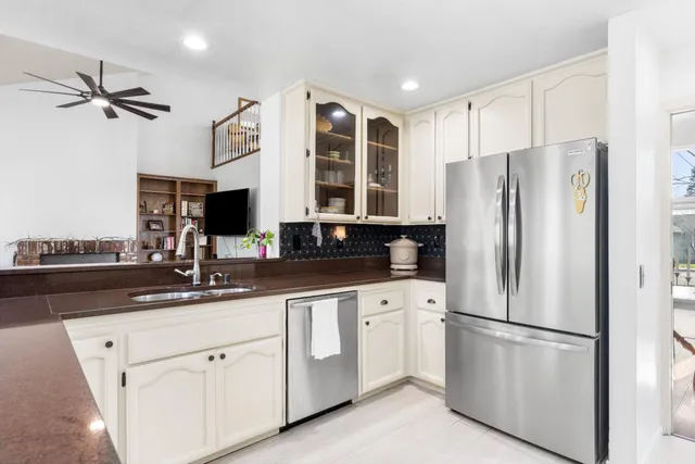 a kitchen with stainless steel appliances a refrigerator sink and cabinets