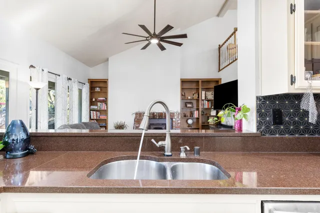 a kitchen with a sink cabinets and a window