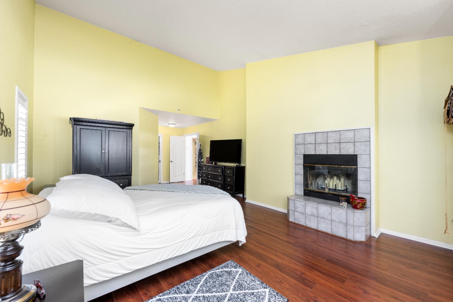 10165 Snowy Owl Way Auburn, CA 95603 - Photo 24 of 48 a bedroom with a bed and a fireplace