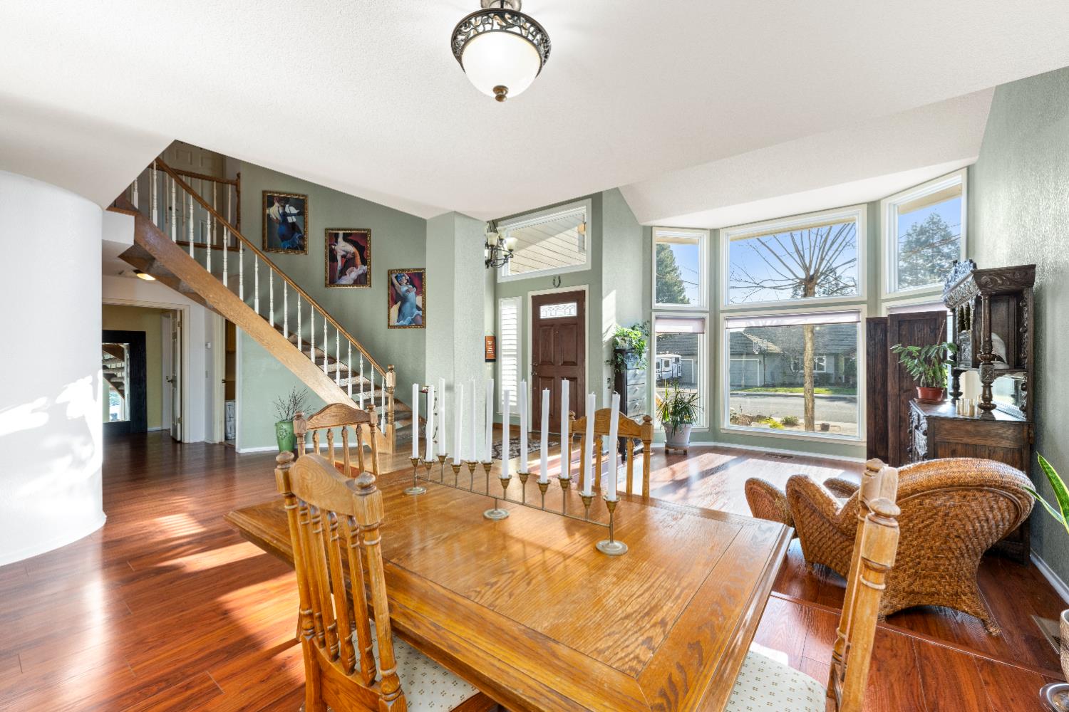 10165 Snowy Owl Way Auburn, CA 95603 - Photo 4 of 48 a dining room with wooden floor a chandelier a glass table and chairs