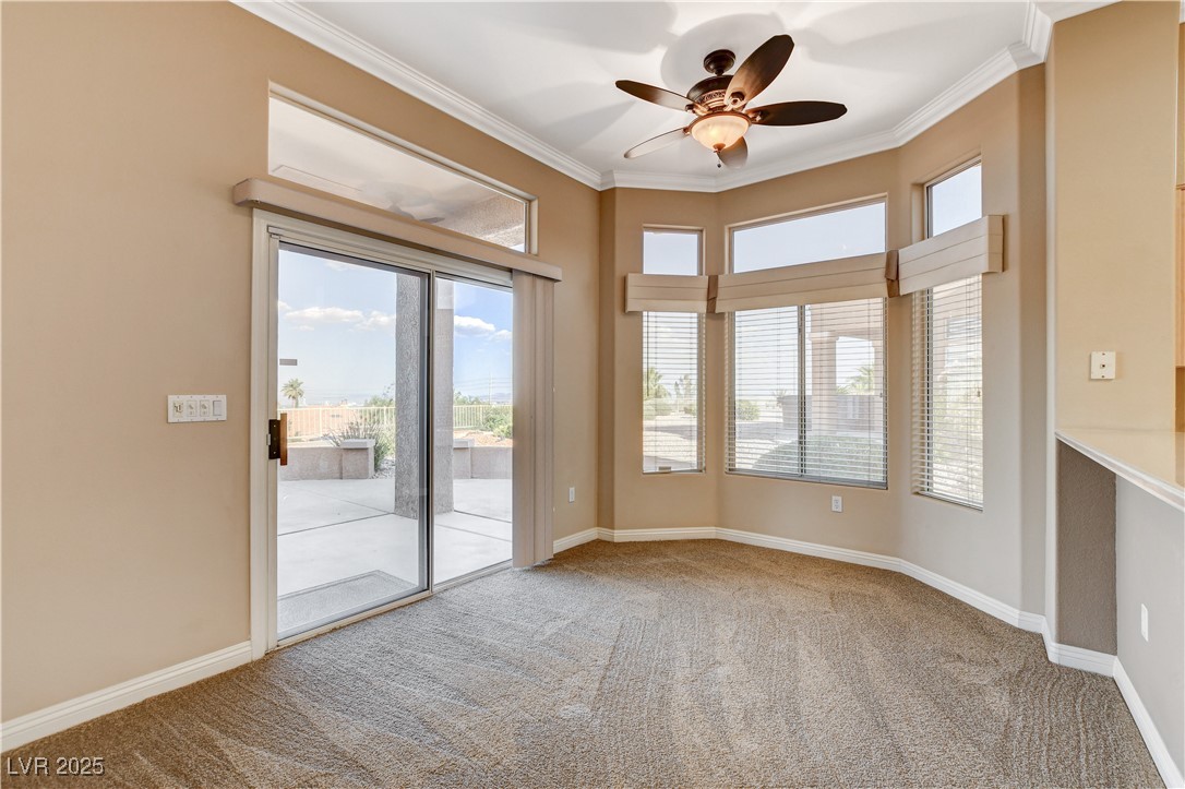 1904 Hot Oak Ridge Street Las Vegas, NV 89134 - Photo 17 of 74 Unfurnished room featuring plenty of natural light, crown molding, light carpet, and ceiling fan