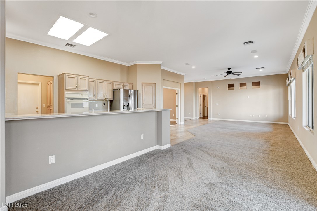 1904 Hot Oak Ridge Street Las Vegas, NV 89134 - Photo 19 of 74 Unfurnished living room featuring crown molding, light colored carpet, and recessed lighting