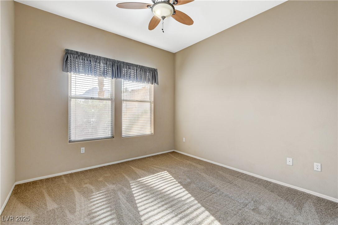 1904 Hot Oak Ridge Street Las Vegas, NV 89134 - Photo 29 of 74 Carpeted spare room with baseboards and ceiling fan