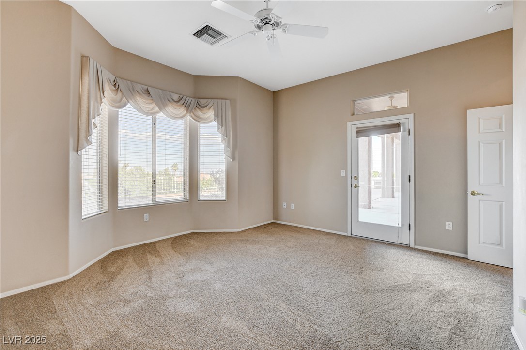 1904 Hot Oak Ridge Street Las Vegas, NV 89134 - Photo 34 of 74 Spare room featuring light colored carpet and a ceiling fan