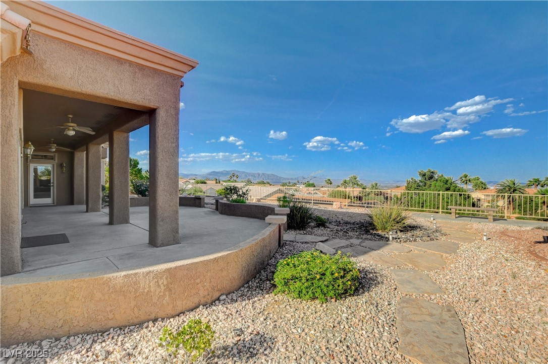 1904 Hot Oak Ridge Street Las Vegas, NV 89134 - Photo 42 of 74 View of yard featuring a patio area, ceiling fan, and a mountain view