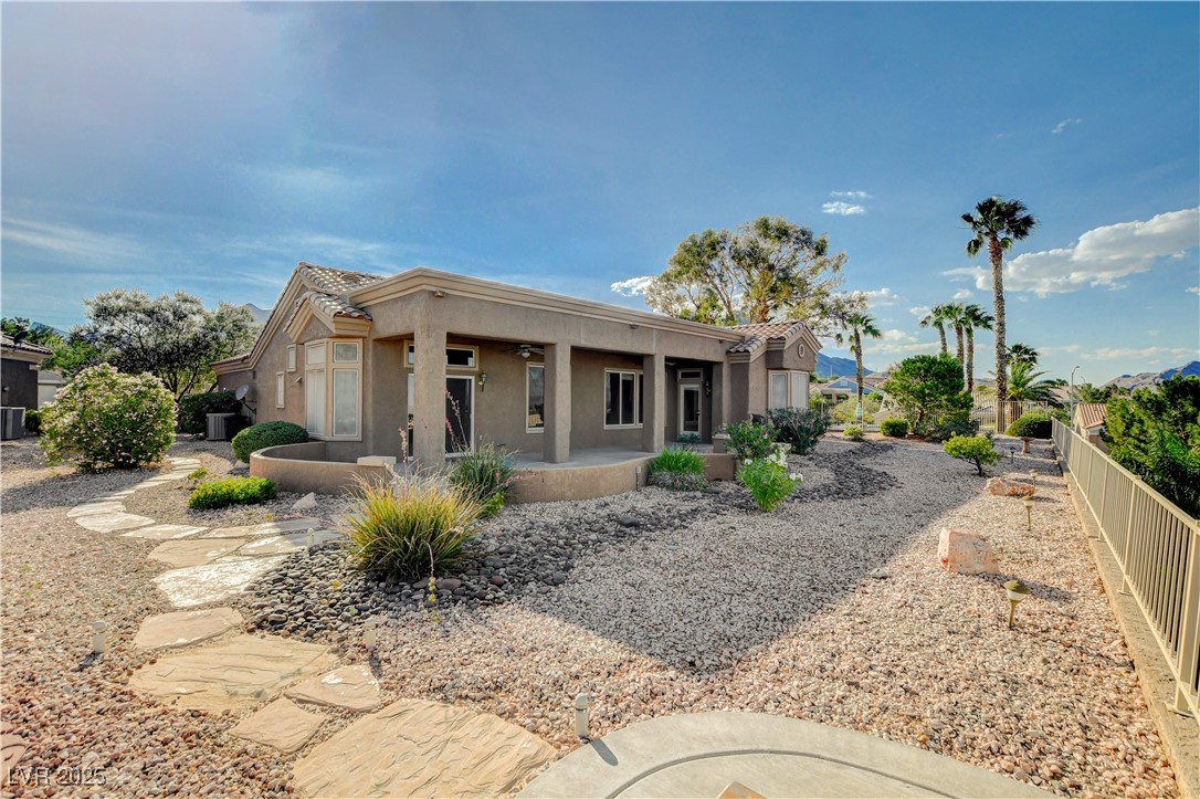 1904 Hot Oak Ridge Street Las Vegas, NV 89134 - Photo 43 of 74 Pueblo-style home with stucco siding, a tiled roof, and covered porch