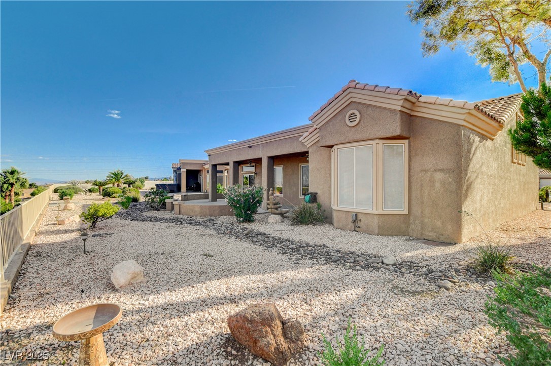 1904 Hot Oak Ridge Street Las Vegas, NV 89134 - Photo 44 of 74 Rear view of property with stucco siding, a porch, and a tile roof