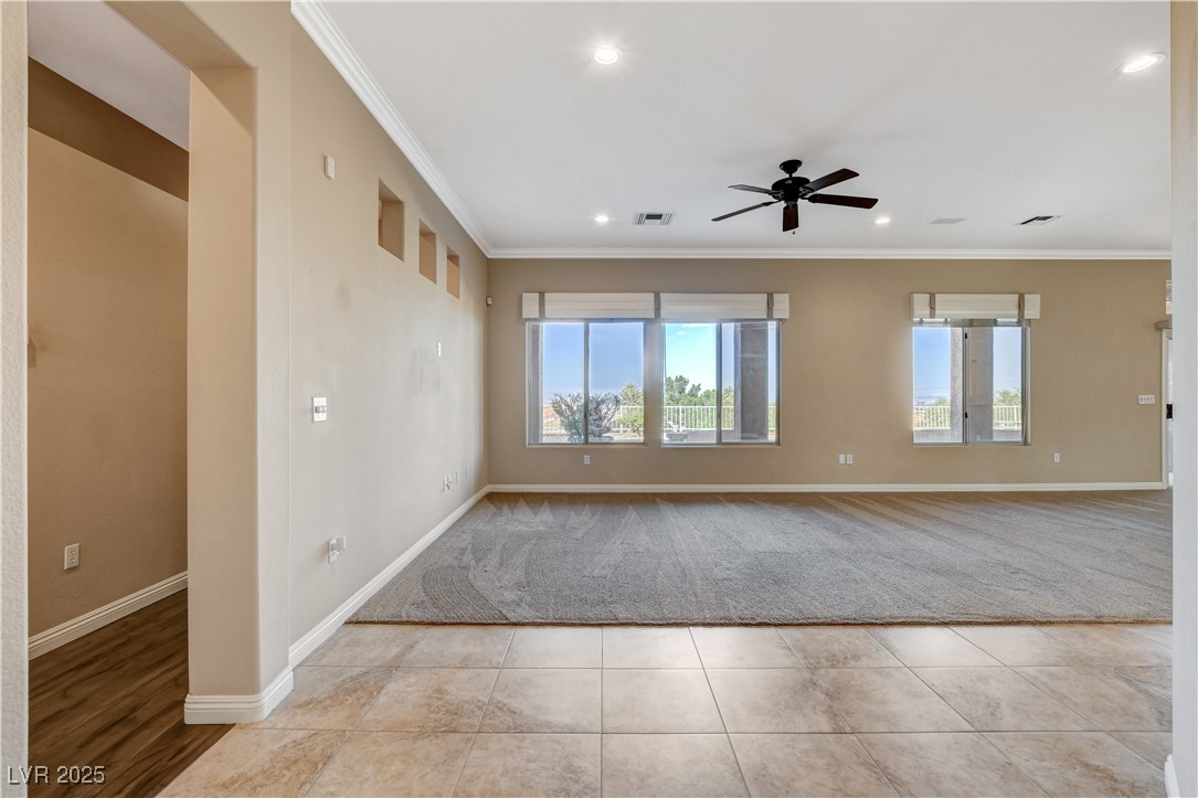 1904 Hot Oak Ridge Street Las Vegas, NV 89134 - Photo 8 of 74 Spare room with crown molding, a ceiling fan, light tile patterned floors, and recessed lighting