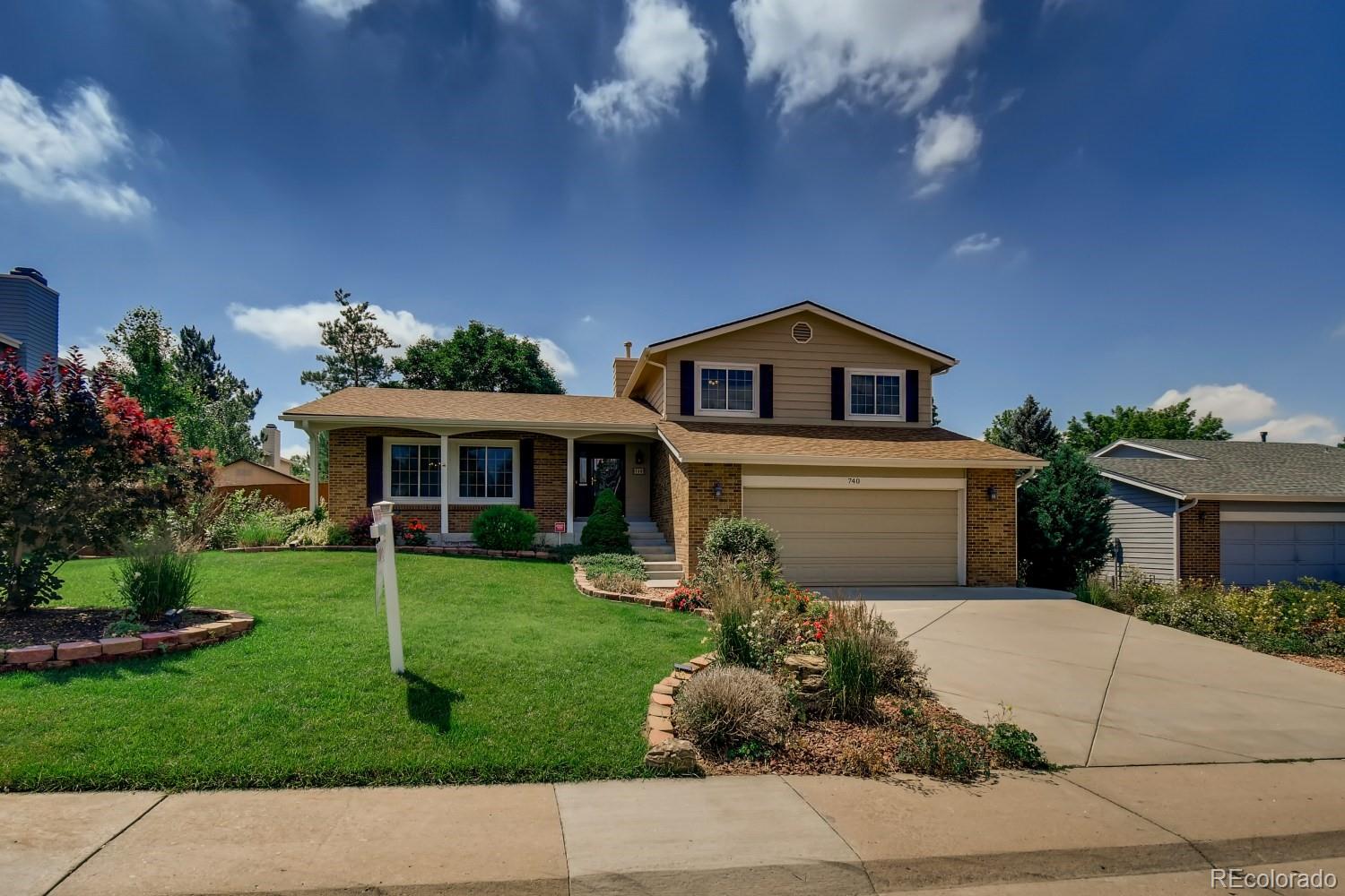 740 Prairie Ridge Road Highlands Ranch, CO 80126 - Photo 1 of 31 a front view of a house with a garden