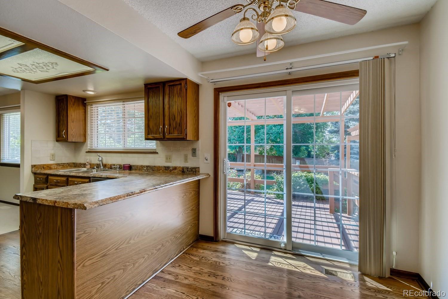 740 Prairie Ridge Road Highlands Ranch, CO 80126 - Photo 14 of 31 a kitchen with granite countertop a stove top oven a sink and cabinets