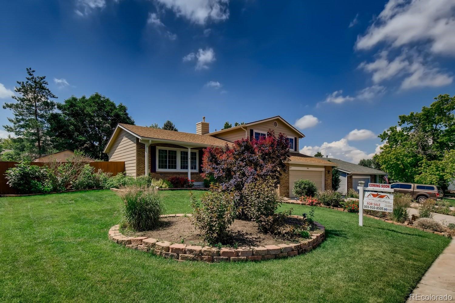 740 Prairie Ridge Road Highlands Ranch, CO 80126 - Photo 2 of 31 a front view of a house with a garden