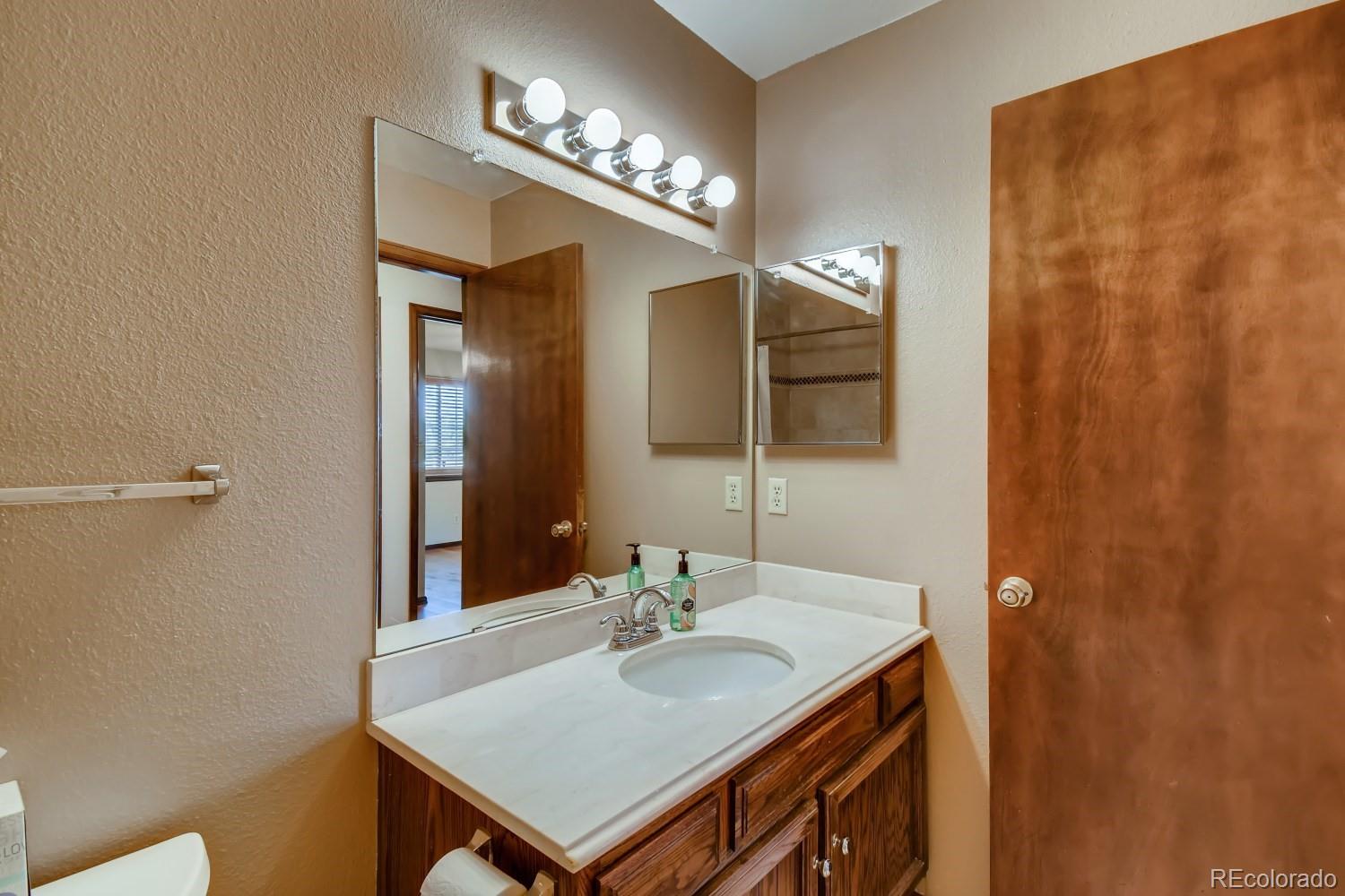 740 Prairie Ridge Road Highlands Ranch, CO 80126 - Photo 23 of 31 a bathroom with a sink and a mirror