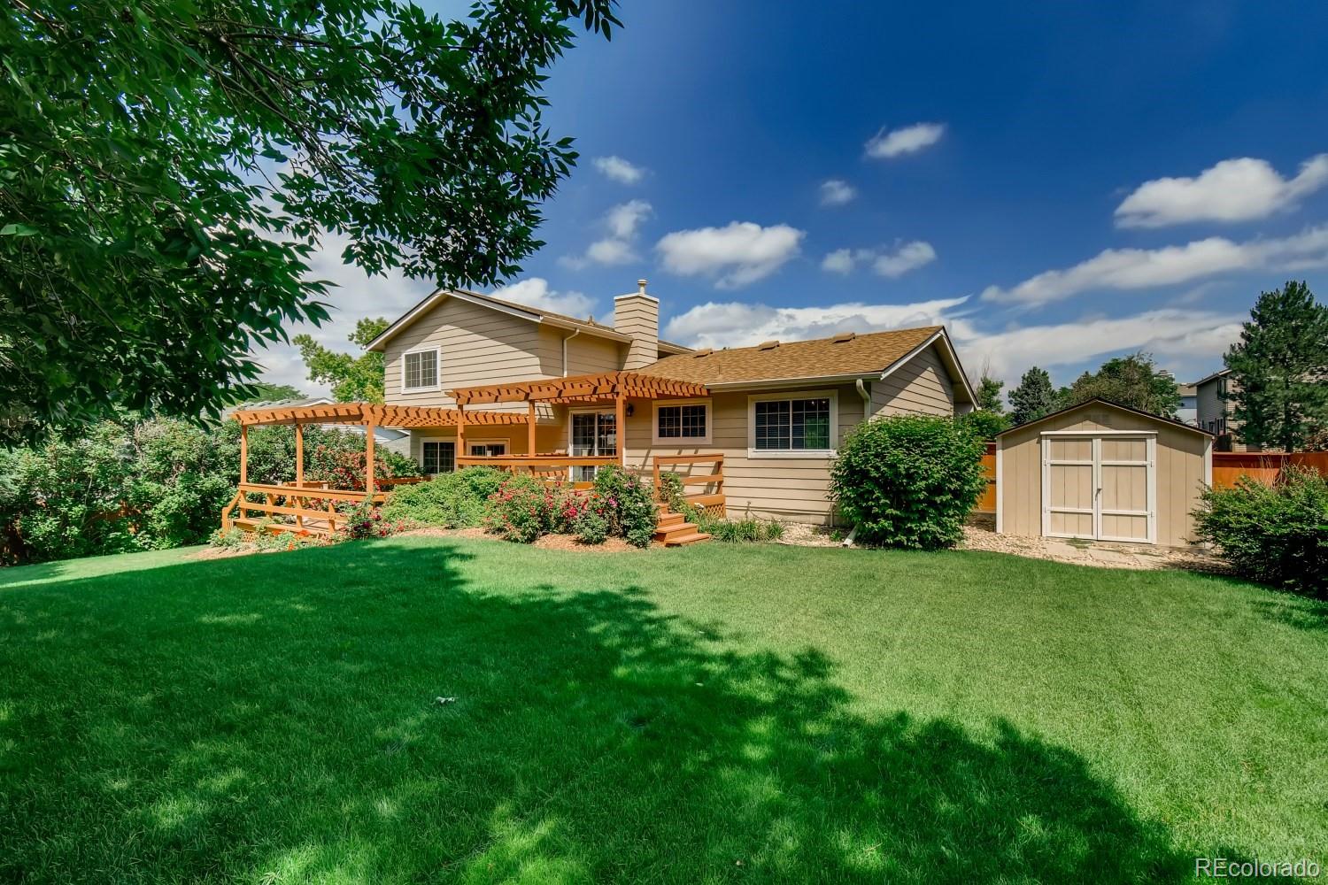 740 Prairie Ridge Road Highlands Ranch, CO 80126 - Photo 27 of 31 a front view of a house with a yard