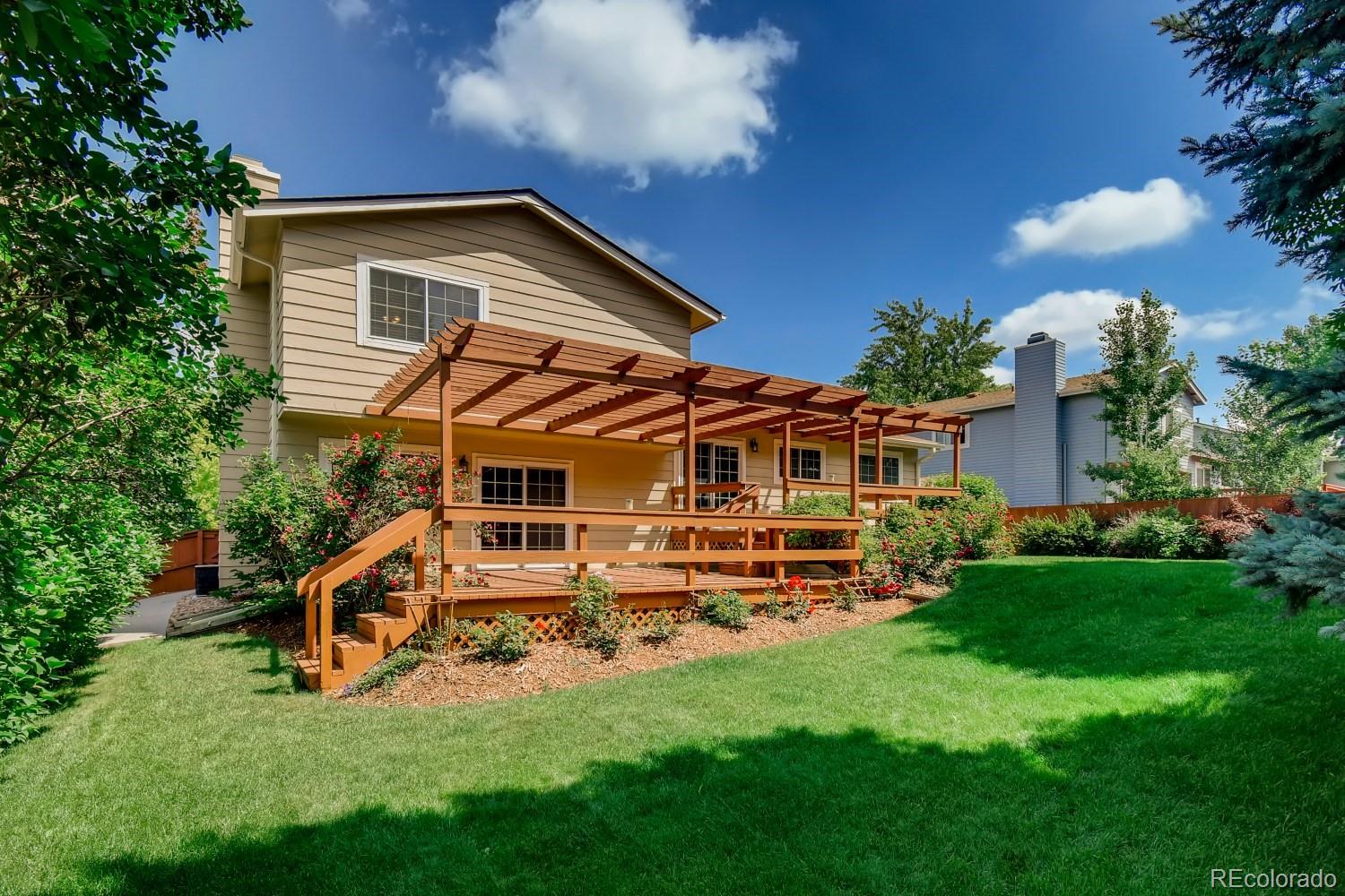 740 Prairie Ridge Road Highlands Ranch, CO 80126 - Photo 28 of 31 a front view of a house with a yard table and chairs