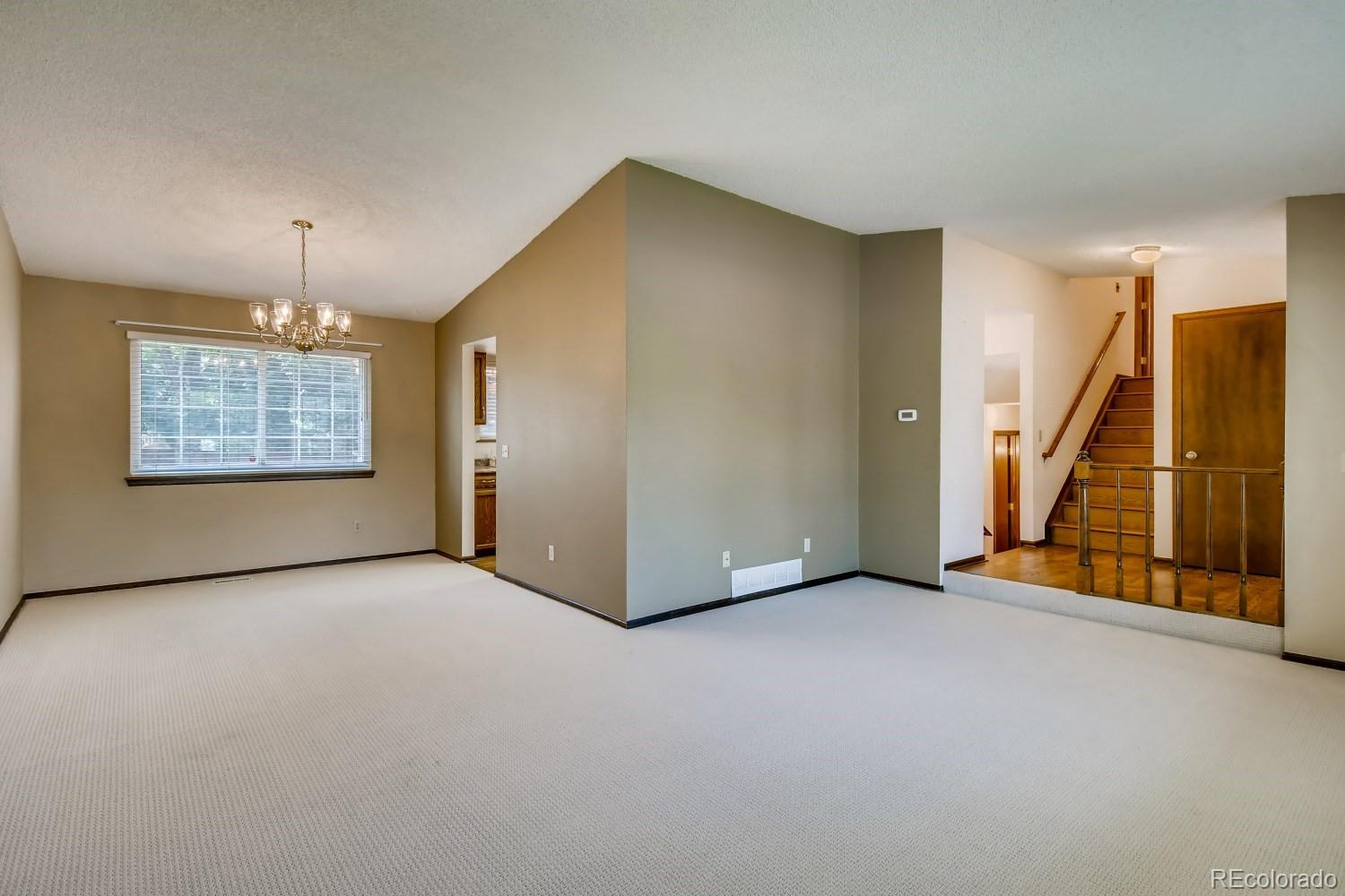 740 Prairie Ridge Road Highlands Ranch, CO 80126 - Photo 6 of 31 an empty room with ceiling fan and windows