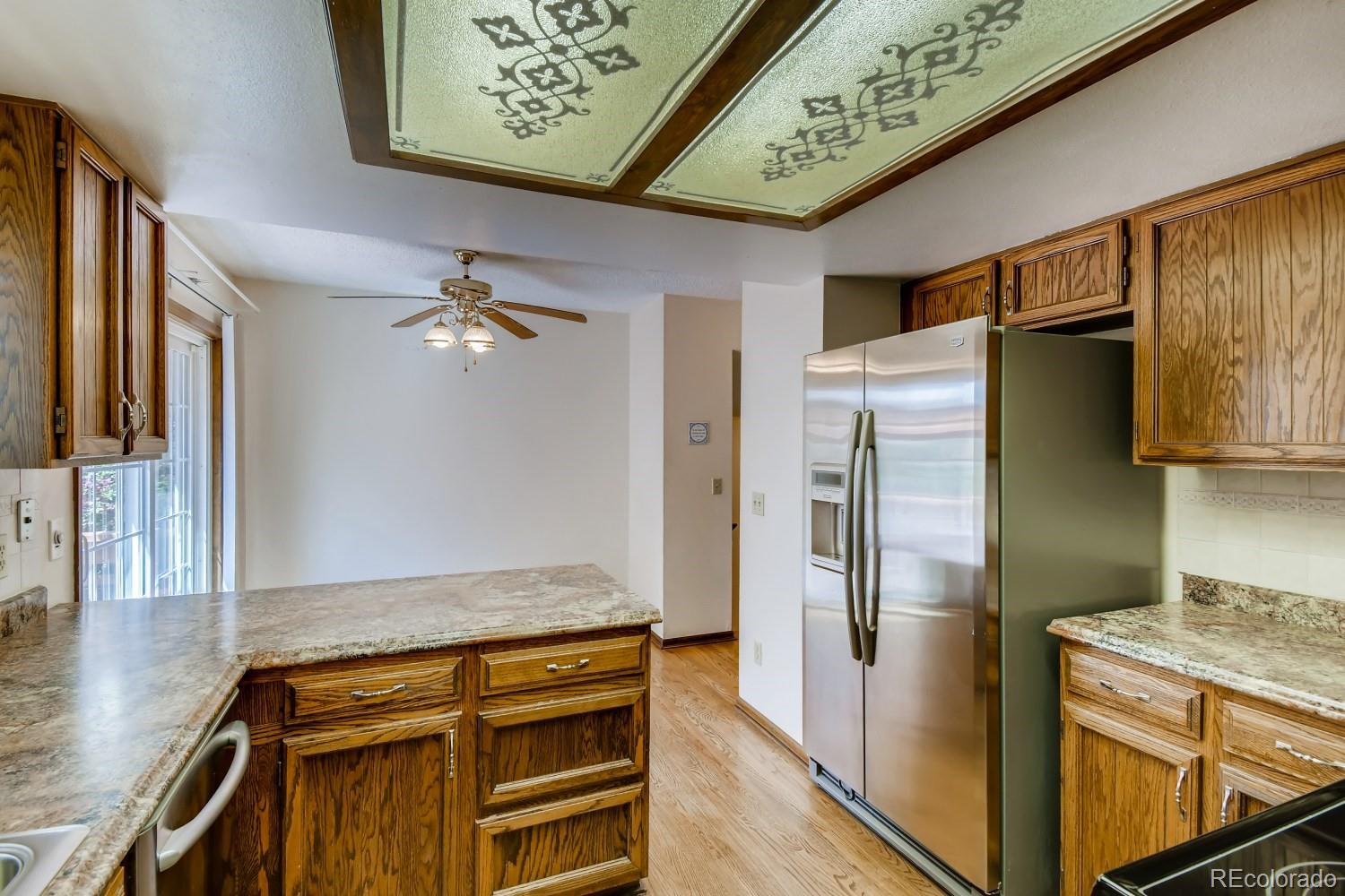 740 Prairie Ridge Road Highlands Ranch, CO 80126 - Photo 9 of 31 a kitchen with stainless steel appliances granite countertop a refrigerator and a stove