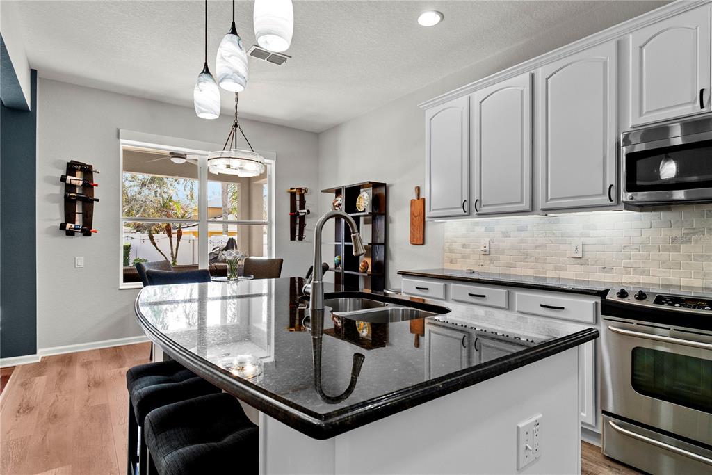 13320 Fernow Street Windermere, FL 34786 - Photo 16 of 52 a kitchen with a sink a microwave and cabinets