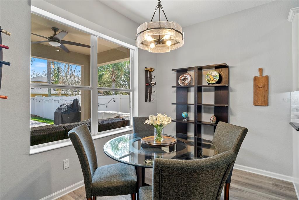 13320 Fernow Street Windermere, FL 34786 - Photo 18 of 52 a view of a dining room with furniture a chandelier and wooden floor