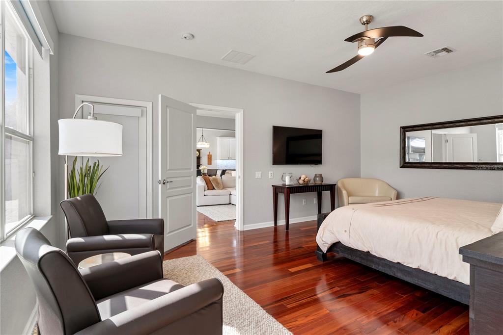 13320 Fernow Street Windermere, FL 34786 - Photo 26 of 52 a bedroom with a bed a couch and a flat tv screen on a dresser