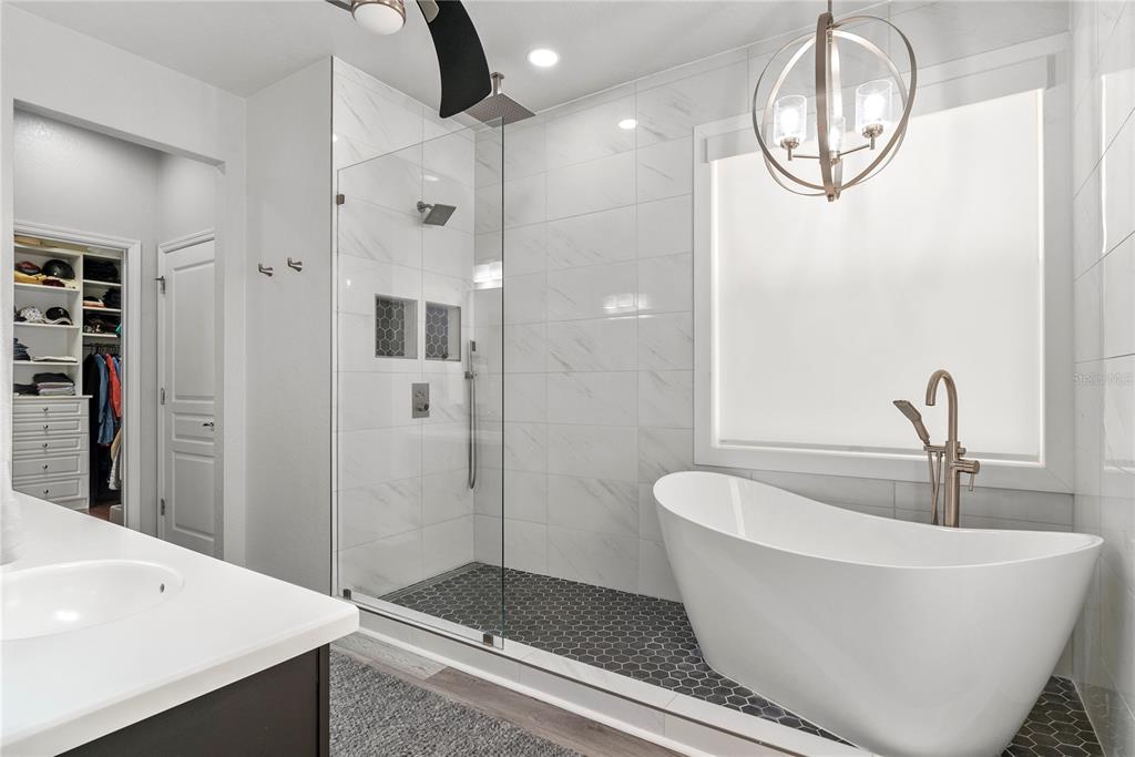 13320 Fernow Street Windermere, FL 34786 - Photo 27 of 52 a bathroom with a white tub shower and mirror