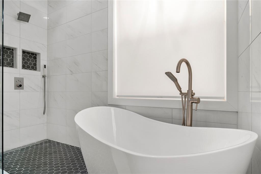 13320 Fernow Street Windermere, FL 34786 - Photo 28 of 52 a white bath tub sitting in a bathroom