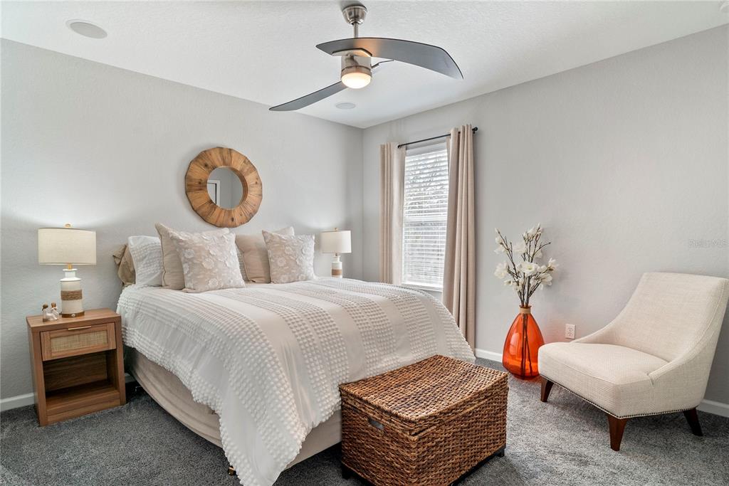 13320 Fernow Street Windermere, FL 34786 - Photo 40 of 52 a bedroom with a bed and a chandelier