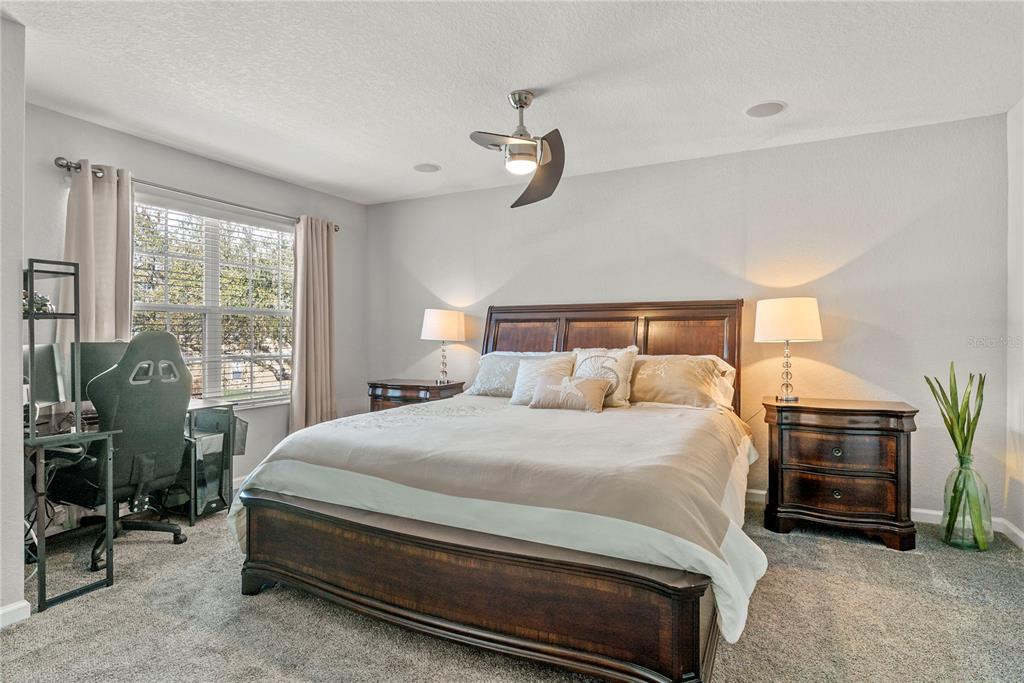 13320 Fernow Street Windermere, FL 34786 - Photo 41 of 52 a bedroom with a bed a couch and potted plant on the dresser