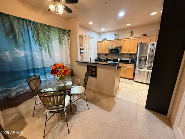 a kitchen with stainless steel appliances kitchen island granite countertop a sink and cabinets