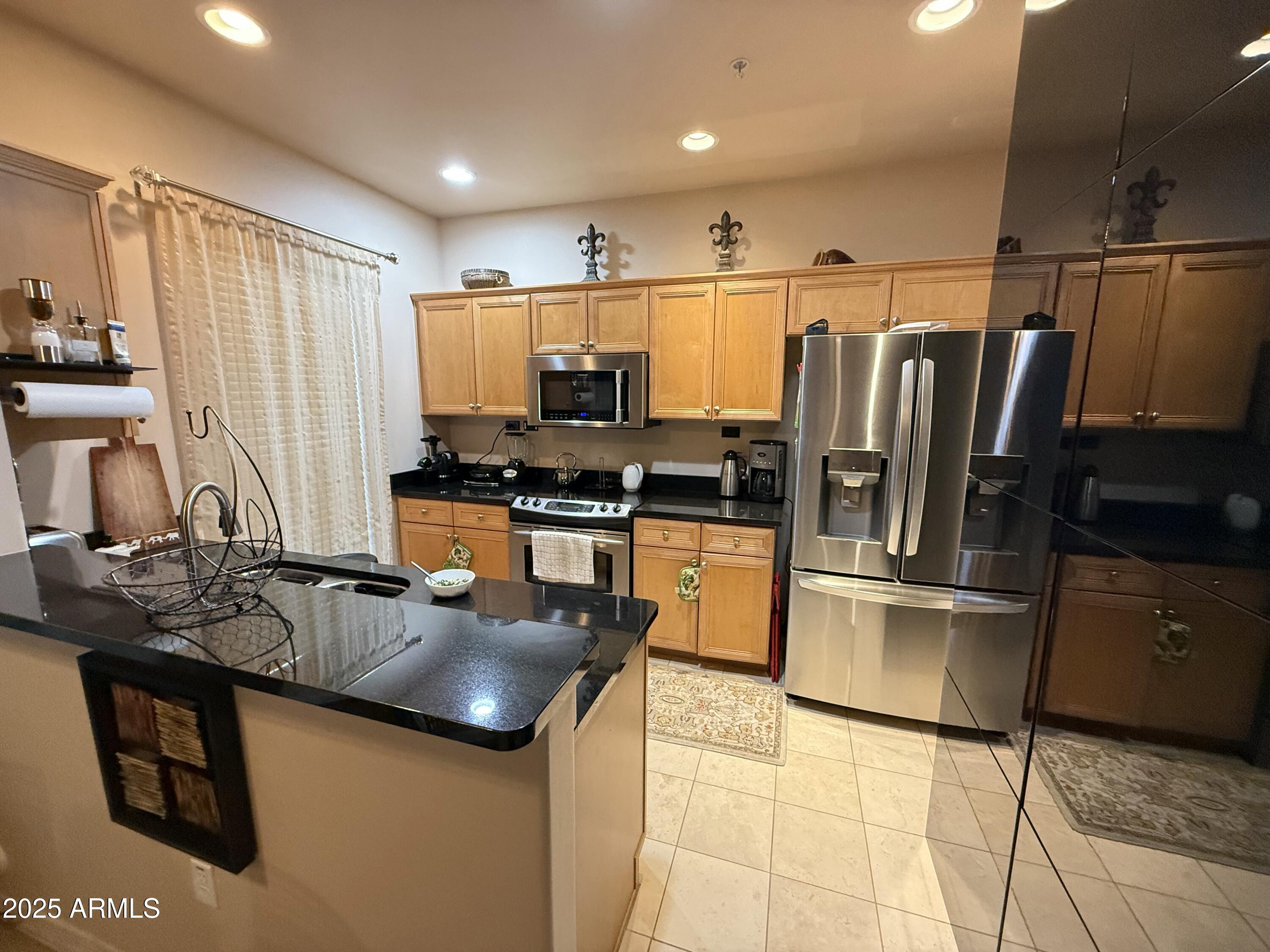 20660 North 40th Street, Unit 2137 Phoenix, AZ 85050 - Photo 13 of 22 a kitchen with stainless steel appliances granite countertop a refrigerator a sink and a stove