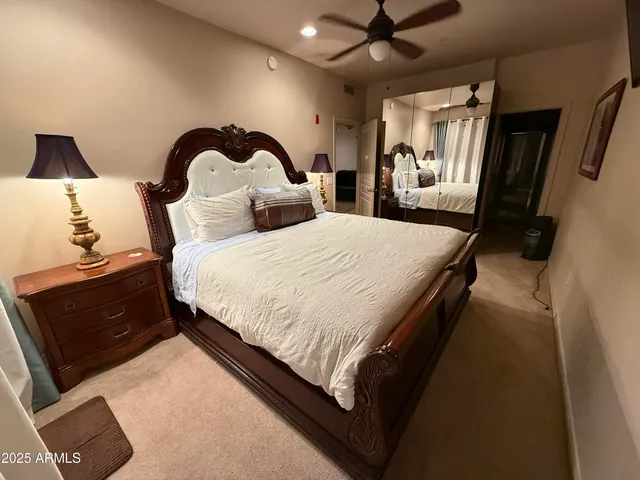 a spacious bedroom with two bed and a dresser