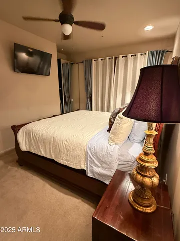 a bedroom with a bed and a television