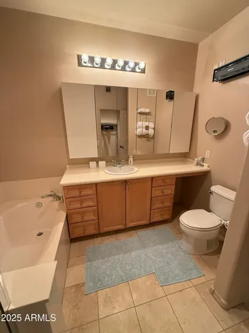a bathroom with a sink a toilet and mirror