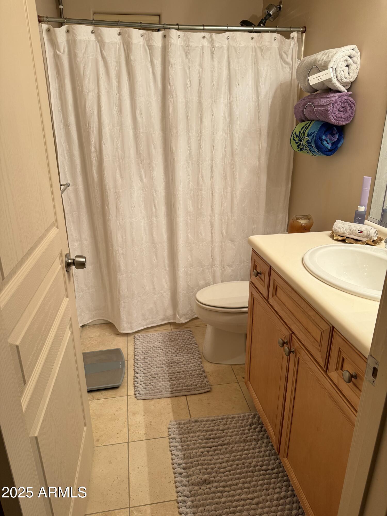 20660 North 40th Street, Unit 2137 Phoenix, AZ 85050 - Photo 20 of 22 a bathroom with a sink a toilet and shower curtain