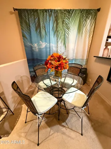 a dining room with furniture and a potted plant