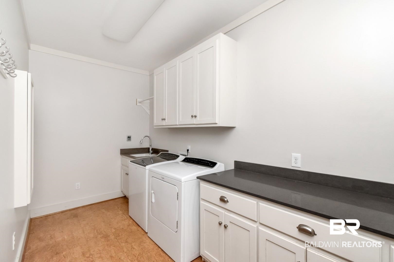 4776 Falls Church Road Mobile, AL 36608 - Photo 35 of 45 Laundry room featuring white cabinetry, a utility sink with a chrome faucet, and dark countertops